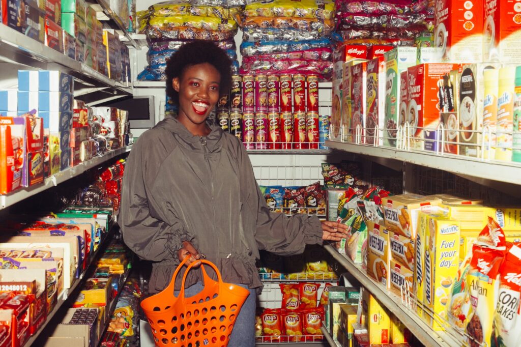 happy woman buying groceries in a convenience store